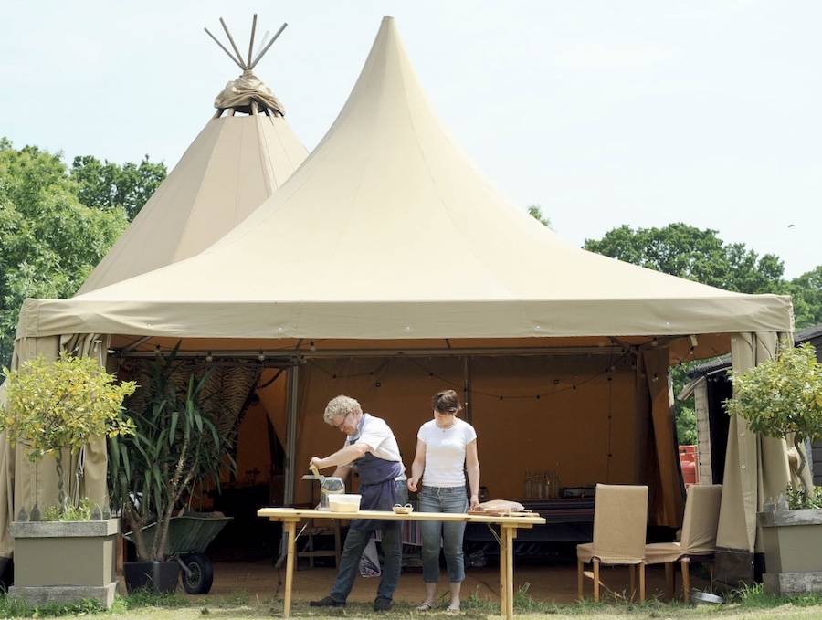 The Catering Tent by Tentipi is being used for its function of preparing food at a wedding.