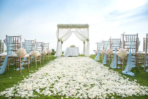 Best Wedding Marquee Hire in UK - Wedding Aisle white flower petals sprinkled on grass