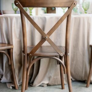 Cross Back Boho wedding chair with decor for guests.