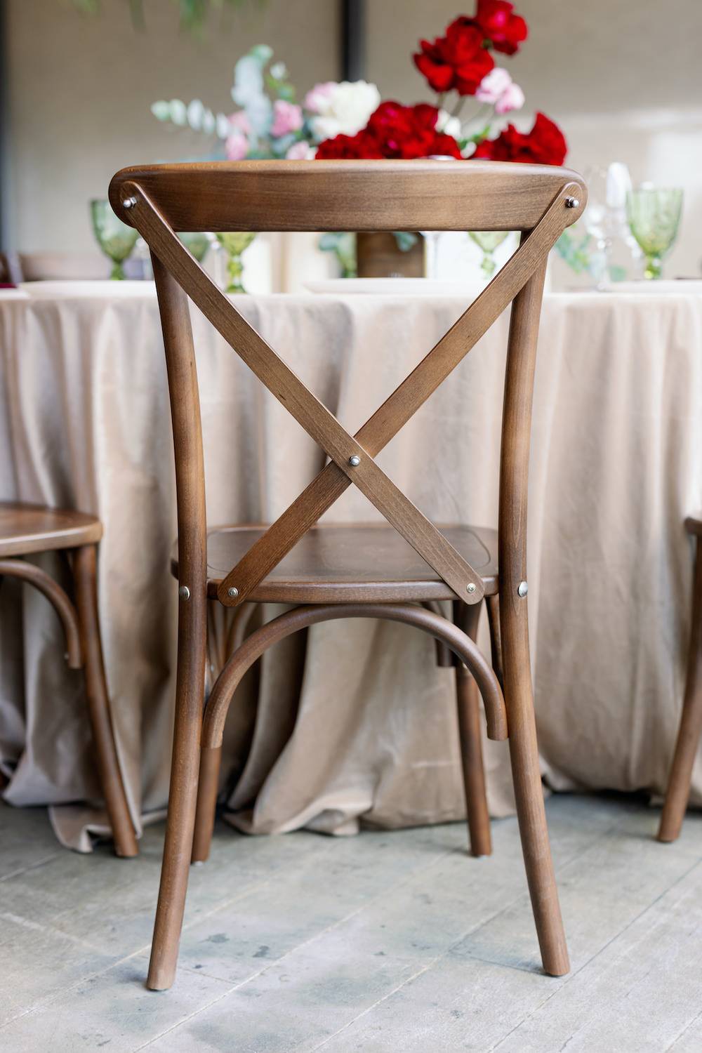Cross Back Boho wedding chair with decor for guests.