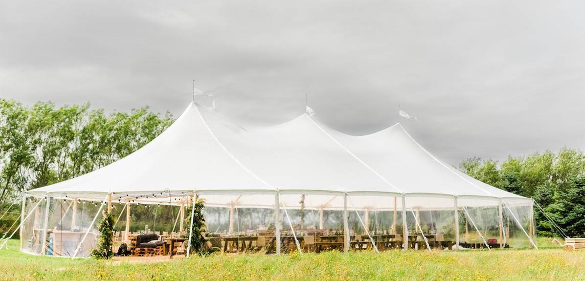 A beautifully decorated marquee in the Kent countryside, prepared for an elegant event.