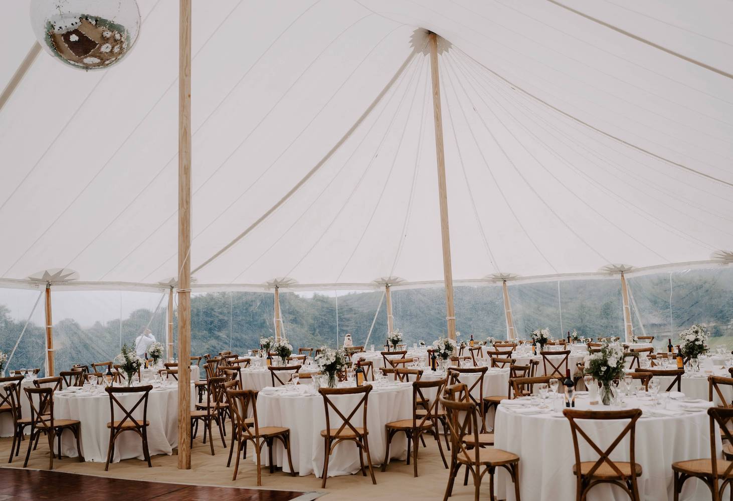 Sailcloth Wedding Marquee Interior: Round Tables, Cross Back Chairs, and Elegant Mirror Ball